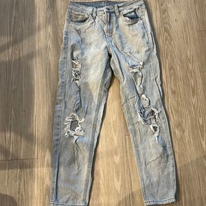 High waisted jeans with holes in the legs.